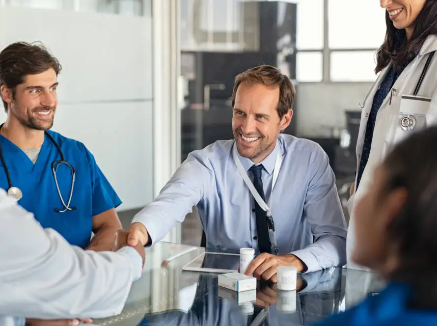 Pulse Digital strategist shaking hands with a clinic consultant during a working session
