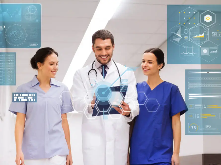 Three smiling healthcare professionals in scrubs and a lab coat review information on a tablet. Transparent digital medical charts and data overlays suggest advanced technology and the expertise of a healthcare digital marketing agency in a modern hospital setting.