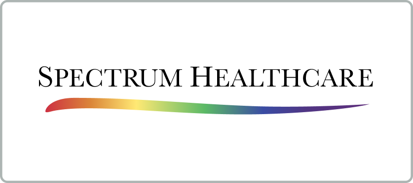 Logo for Spectrum Healthcare. The text SPECTRUM HEALTHCARE appears in black uppercase letters above a curved line that fades from red to purple, displaying a rainbow gradient. The background is white with rounded grey borders.